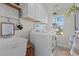 Functional laundry room with modern appliances and ample cabinet space at 168 Amber Acorn Ave, Raleigh, NC 27603