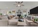 Bright living room featuring a fireplace, ceiling fan, and comfortable sectional sofa at 168 Amber Acorn Ave, Raleigh, NC 27603