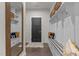 Well-organized mudroom with built-in benches, storage shelves, and a decorative mirror at 168 Amber Acorn Ave, Raleigh, NC 27603