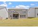 Exterior shot of the back of the home showcasing the manicured lawn at 170 Creekhaven Dr, Angier, NC 27501