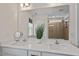 Bright bathroom features a double vanity with white countertops, modern fixtures, and a large mirror reflecting the shower at 170 Creekhaven Dr, Angier, NC 27501