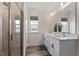 Bathroom featuring a double vanity, a large mirror, and a tiled walk-in shower at 170 Creekhaven Dr, Angier, NC 27501