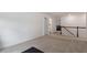 Open carpeted bonus room with staircase and door leading to another space at 170 Creekhaven Dr, Angier, NC 27501