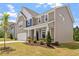 Inviting two-story home with a two car garage, landscaped front yard, and covered front porch at 170 Creekhaven Dr, Angier, NC 27501