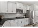 Modern kitchen with stainless steel appliances, granite countertops, and white cabinets at 170 Creekhaven Dr, Angier, NC 27501