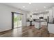 Open-concept kitchen with granite countertops, an island, and sliding glass door leading to the yard at 170 Creekhaven Dr, Angier, NC 27501