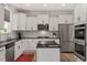 Bright, modern kitchen features white cabinets, stainless steel appliances, and a kitchen island at 170 Creekhaven Dr, Angier, NC 27501