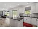 Bright open kitchen with white cabinets, an island, granite countertops, and stainless appliances at 170 Creekhaven Dr, Angier, NC 27501