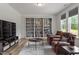 Cozy living room featuring a large built-in bookcase, television, and comfortable seating area at 170 Creekhaven Dr, Angier, NC 27501