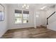 Bright living room with wood floors, large windows, and staircase access at 170 Creekhaven Dr, Angier, NC 27501