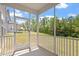 Relaxing screened-in porch offering views of the yard and trees at 170 Creekhaven Dr, Angier, NC 27501