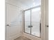 Modern bathroom featuring tiled shower, glass door, and crisp white walls at 171 Alice Trace Place, Angier, NC 27501