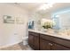 Bathroom featuring a double sink vanity with framed mirror and white floral arrangement at 171 Alice Trace Place, Angier, NC 27501