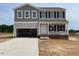 Two-story home featuring an attached garage, black window shutters, and a covered front entryway at 171 Alice Trace Place, Angier, NC 27501