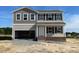 Two-story home showcasing a spacious garage, classic windows and neutral-toned siding at 171 Alice Trace Place, Angier, NC 27501