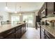 The kitchen has dark wood cabinets, granite countertops and stainless steel appliances at 171 Alice Trace Place, Angier, NC 27501