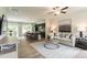 Open-concept living area with kitchen island, modern furniture, and ample natural light at 171 Alice Trace Place, Angier, NC 27501