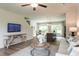 Open-concept living room and dining area with a TV and modern furnishings at 171 Alice Trace Place, Angier, NC 27501