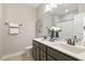 Bathroom with dual sink vanity, decorative mirror, modern fixtures, and neutral paint at 1723 River Club Way, Franklinton, NC 27525