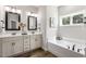 This bathroom features double sinks, a soaking tub, and tile flooring at 1723 River Club Way, Franklinton, NC 27525