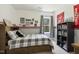 Cozy bedroom featuring plaid comforter, fun decor, and a built-in bookcase for storage at 1723 River Club Way, Franklinton, NC 27525