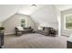 Spacious bonus room features plush carpeting, neutral paint, and a large window at 1723 River Club Way, Franklinton, NC 27525