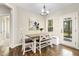 Bright dining area with wood floors, white bench seating and sliding glass door to the porch at 1723 River Club Way, Franklinton, NC 27525