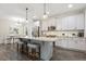The kitchen includes an island with stool seating and stainless steel appliances and is open to the dining room at 1723 River Club Way, Franklinton, NC 27525