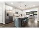The kitchen features an island with stool seating, stainless steel appliances and is open to the living room at 1723 River Club Way, Franklinton, NC 27525