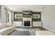 The living room has a beautiful fireplace, dark accent wall, and windows with natural light at 1723 River Club Way, Franklinton, NC 27525
