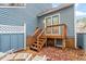 Charming backyard featuring a raised wood deck, stairs, and an outdoor seating area at 1725 Briarforest Pl, Raleigh, NC 27615