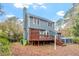 Backyard featuring a spacious wood deck, a well-maintained yard, and lush landscaping at 1725 Briarforest Pl, Raleigh, NC 27615