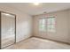 Comfortable bedroom with a mirrored closet and window providing ample natural light at 1725 Briarforest Pl, Raleigh, NC 27615