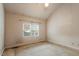 Bedroom features a large window and vaulted ceiling at 1725 Briarforest Pl, Raleigh, NC 27615