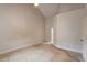 Primary bedroom features vaulted ceiling and neutral walls and carpet at 1725 Briarforest Pl, Raleigh, NC 27615
