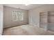 Bright bedroom featuring natural light from the large window and built-in shelving at 1725 Briarforest Pl, Raleigh, NC 27615