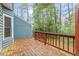 Inviting outdoor deck with wood railings, offering a cozy space to relax and enjoy the surrounding nature at 1725 Briarforest Pl, Raleigh, NC 27615