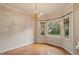 Dining room with hardwood floors, a chandelier, and a large bay window offering natural light at 1725 Briarforest Pl, Raleigh, NC 27615