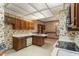 Spacious kitchen features wood cabinets, tiled floors, and white appliances at 1725 Briarforest Pl, Raleigh, NC 27615