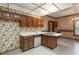Functional kitchen with a double sink, dishwasher, and built-in cabinets adjacent to the dining area at 1725 Briarforest Pl, Raleigh, NC 27615