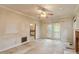 Spacious living room featuring a fireplace, glass doors, and an open view into the adjacent room at 1725 Briarforest Pl, Raleigh, NC 27615