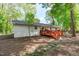 Exterior view of the backyard featuring a deck and a brick-laid path at 1805 Holly St, Apex, NC 27502