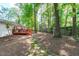 Large backyard including a deck, storage shed, and lush landscaping at 1805 Holly St, Apex, NC 27502