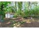 Backyard features a storage shed surrounded by natural landscaping at 1805 Holly St, Apex, NC 27502