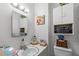 Cozy bathroom featuring a sink, mirror, and cabinetry for storage at 1805 Holly St, Apex, NC 27502
