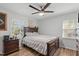 Cozy bedroom featuring a comfortable bed, dark wooden furniture, and a ceiling fan at 1805 Holly St, Apex, NC 27502