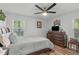 Bright bedroom featuring a comfortable bed, dresser, and a ceiling fan at 1805 Holly St, Apex, NC 27502