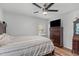 A view to the foot of the bed showing a dresser, window and ceiling fan at 1805 Holly St, Apex, NC 27502