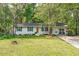 Charming single-story home featuring a brick facade, bright green shutters and lush landscaping at 1805 Holly St, Apex, NC 27502
