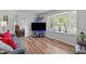 Living room featuring hardwood flooring, bay window, and a view into an adjacent room at 1805 Holly St, Apex, NC 27502